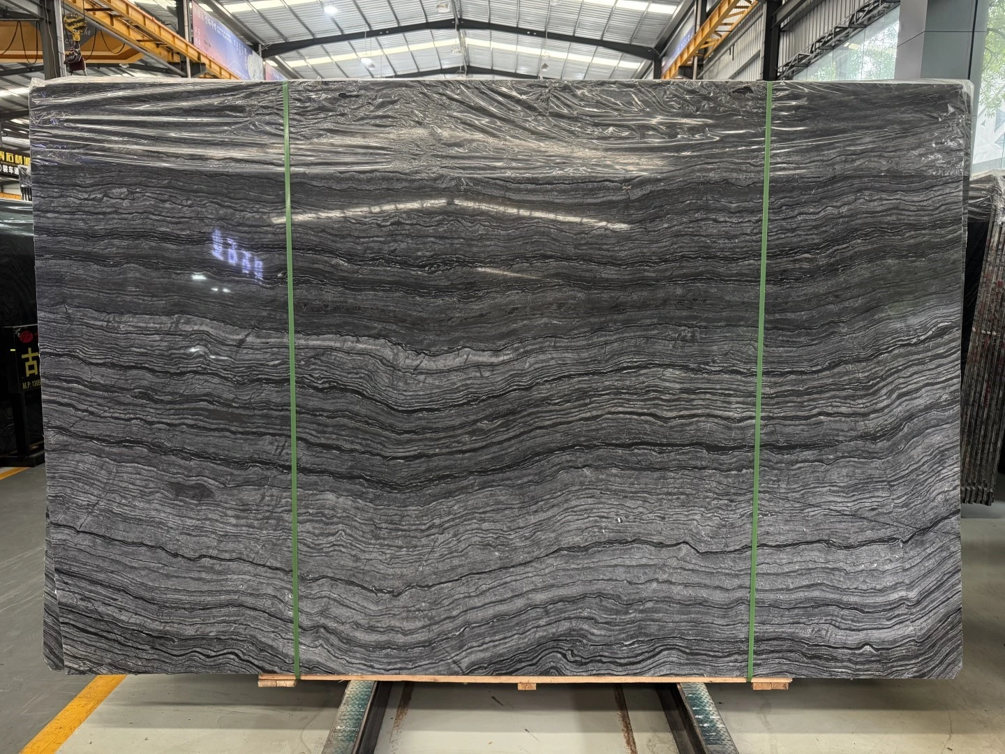Zebra Black marble slab with layered silver-gray horizontal veining displayed at Landiview Stone factory Zebra Black marble slab with layered silver-gray horizontal veining displayed at Landiview Stone factory